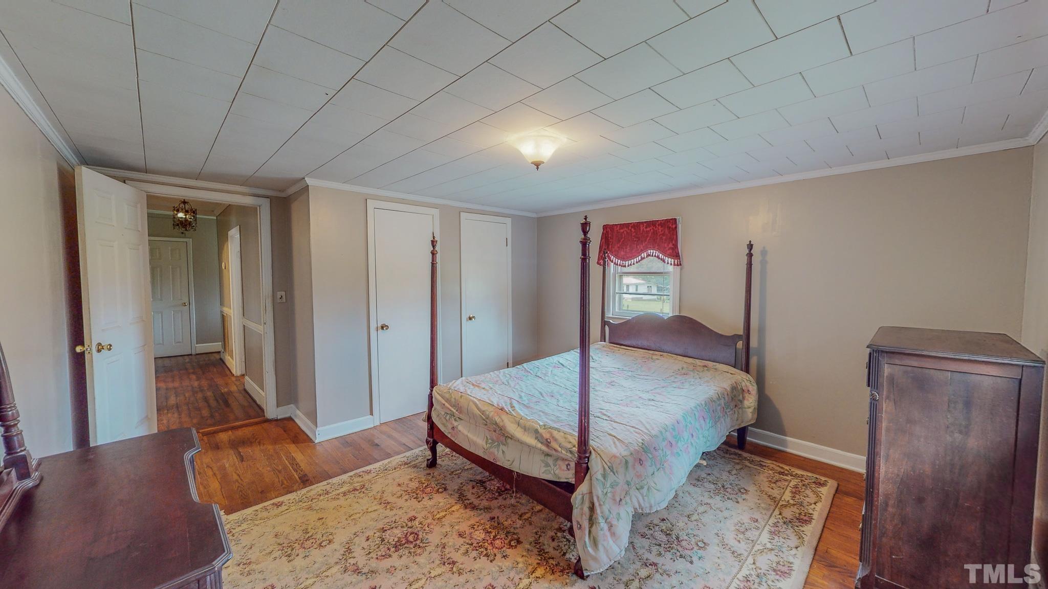 1556 Gentry-Dunkley Road Roxboro, NC 27574 - Photo 37 of 47 a bedroom with a bed and a dresser