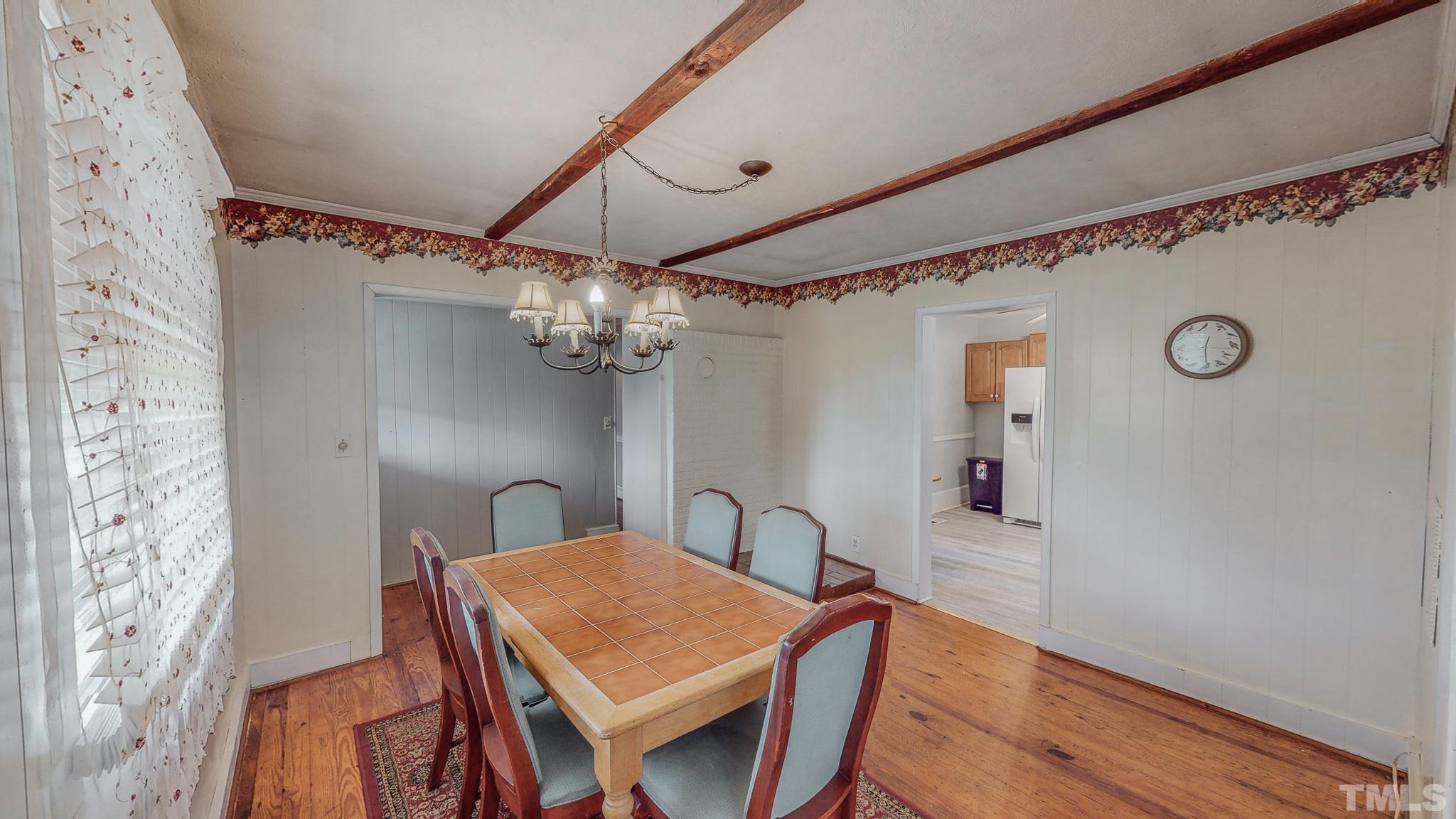 1556 Gentry-Dunkley Road Roxboro, NC 27574 - Photo 4 of 47 a view of a dining room with furniture and wooden floor