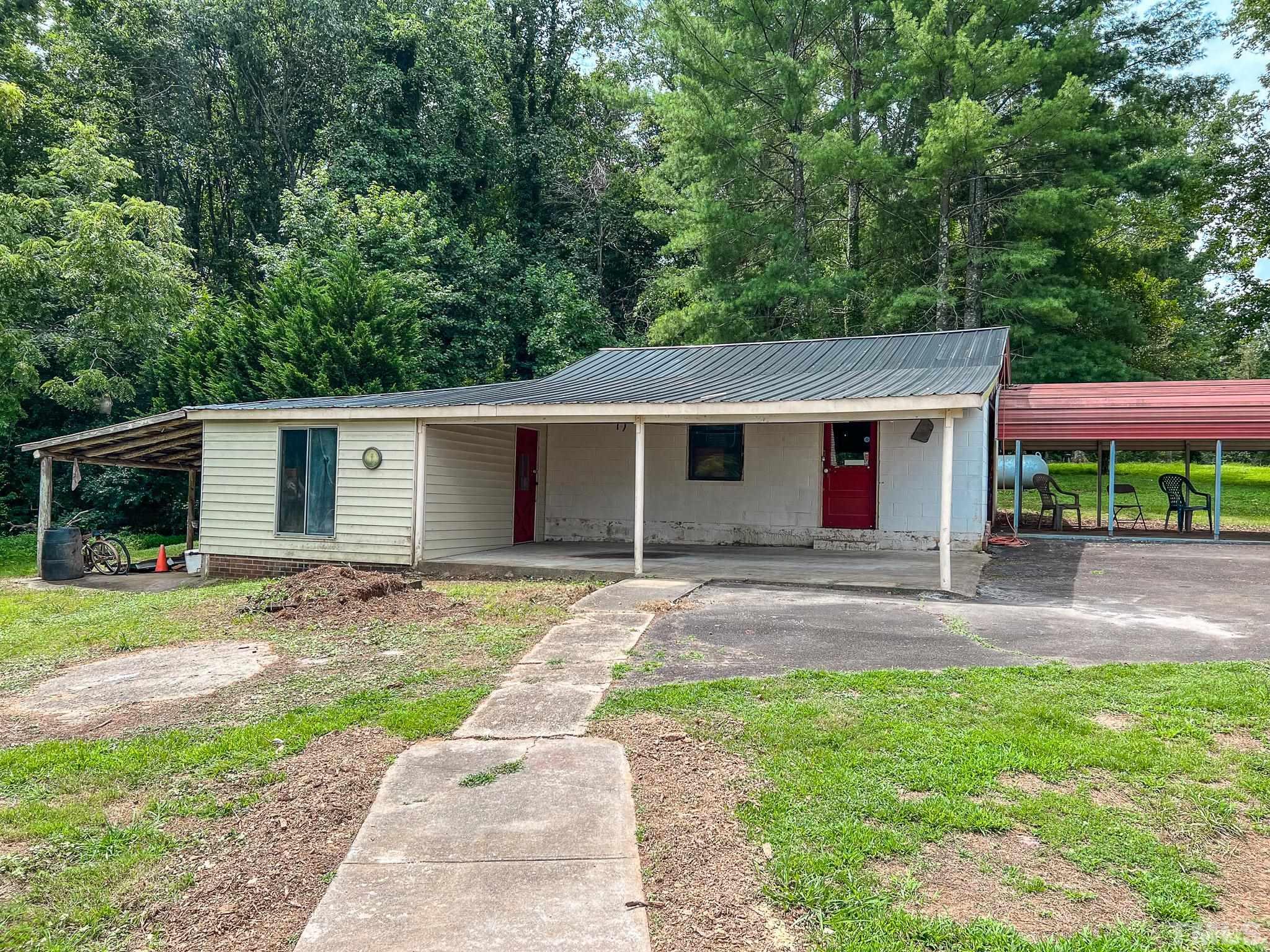 1556 Gentry-Dunkley Road Roxboro, NC 27574 - Photo 7 of 47 front view of a house with a yard