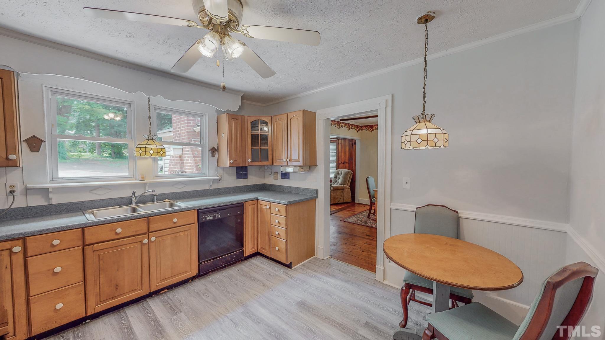 1556 Gentry-Dunkley Road Roxboro, NC 27574 - Photo 9 of 47 a kitchen with sink cabinets and wooden floor