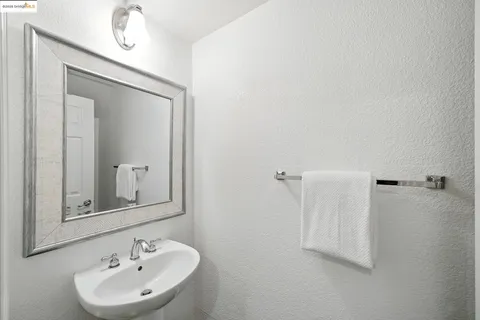 a bathroom with a sink a mirror and vanity