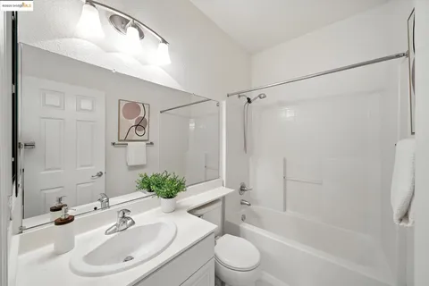 a bedroom with a bed and a mirror