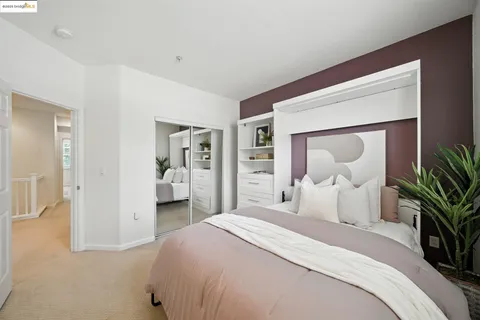 a bedroom with a bed and a potted plant