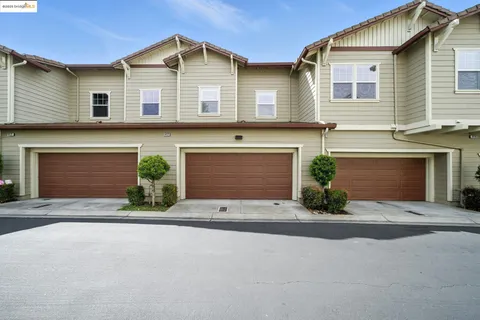 a front view of a house with yard and garage