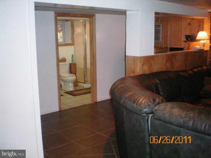 5105 Shelbourne Road Halethorpe, MD 21227 - Photo 23 of 30 a living room with a couch and a potted plant on it