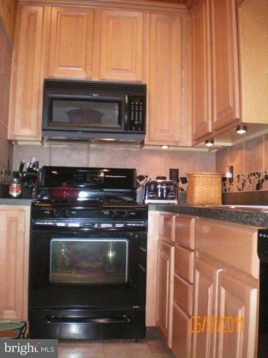 5105 Shelbourne Road Halethorpe, MD 21227 - Photo 29 of 30 a stove top oven sitting inside of a kitchen