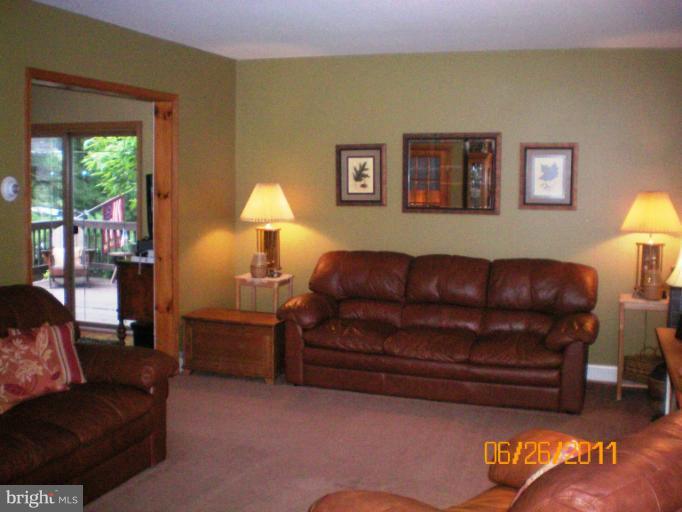 5105 Shelbourne Road Halethorpe, MD 21227 - Photo 10 of 30 a living room with a couch and a lamp next to a window