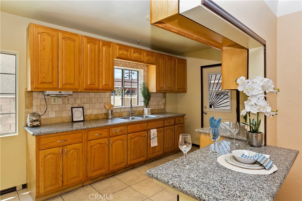617 South Chester Avenue Compton, CA 90221 - Photo 14 of 34 a kitchen with a sink and cabinets