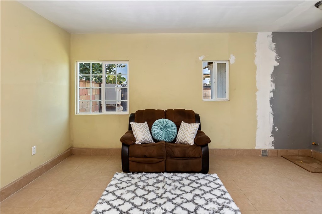 617 South Chester Avenue Compton, CA 90221 - Photo 27 of 34 a bedroom with a bed and wooden floor