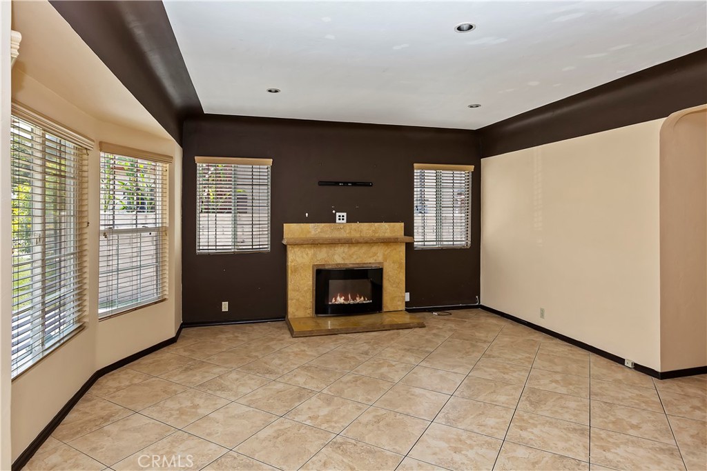 617 South Chester Avenue Compton, CA 90221 - Photo 9 of 34 a view of an empty room with a fireplace and a window