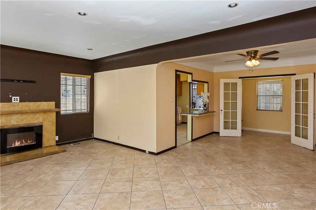 617 South Chester Avenue Compton, CA 90221 - Photo 10 of 34 a view of an empty room with a fireplace and a window