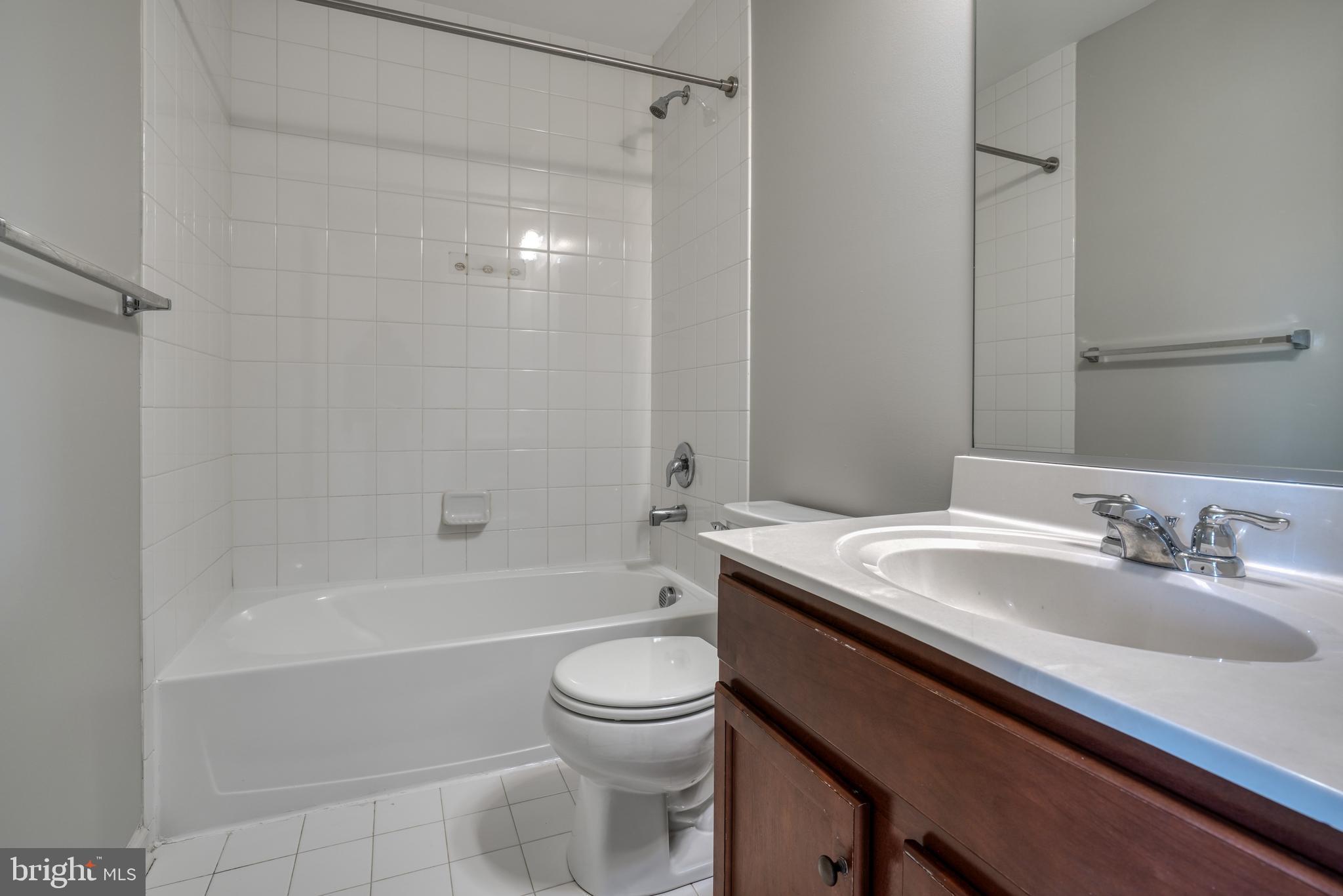 985 Morgan Run Road Middle River, MD 21220 - Photo 22 of 33 a bathroom with a granite countertop sink toilet a mirror and shower