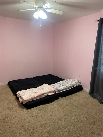 a bed sitting in a room next to a window