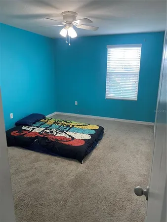a room with a bed and a chandelier
