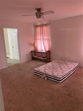a living room with a bed and a window