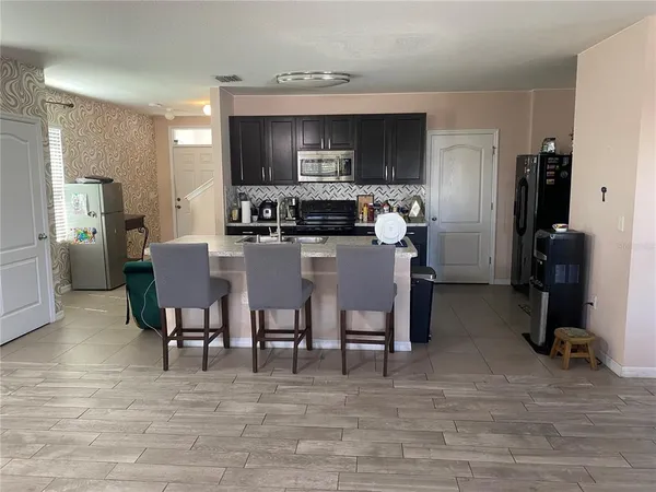 a view of a dining room kitchen with furniture and a wooden floor
