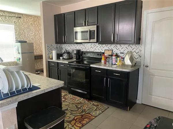 a kitchen with stainless steel appliances wooden cabinets and stove