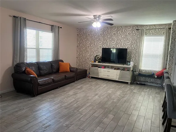 a living room with furniture and a flat screen tv