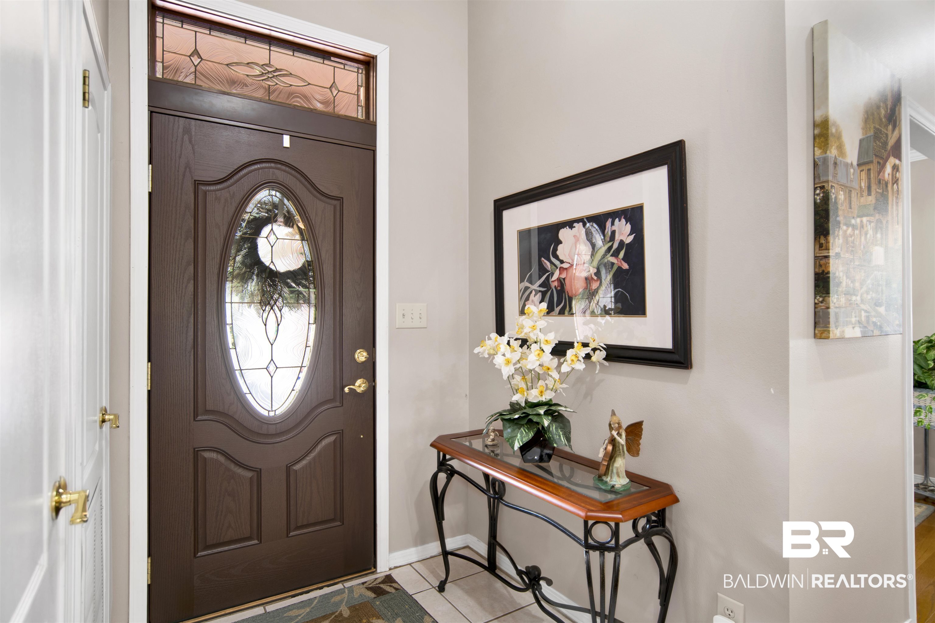 107 Virginia Circle Daphne, AL 36526 - Photo 6 of 47 Entryway featuring a dark wood-finish front door with an oval leaded glass insert and a decorative transom window
