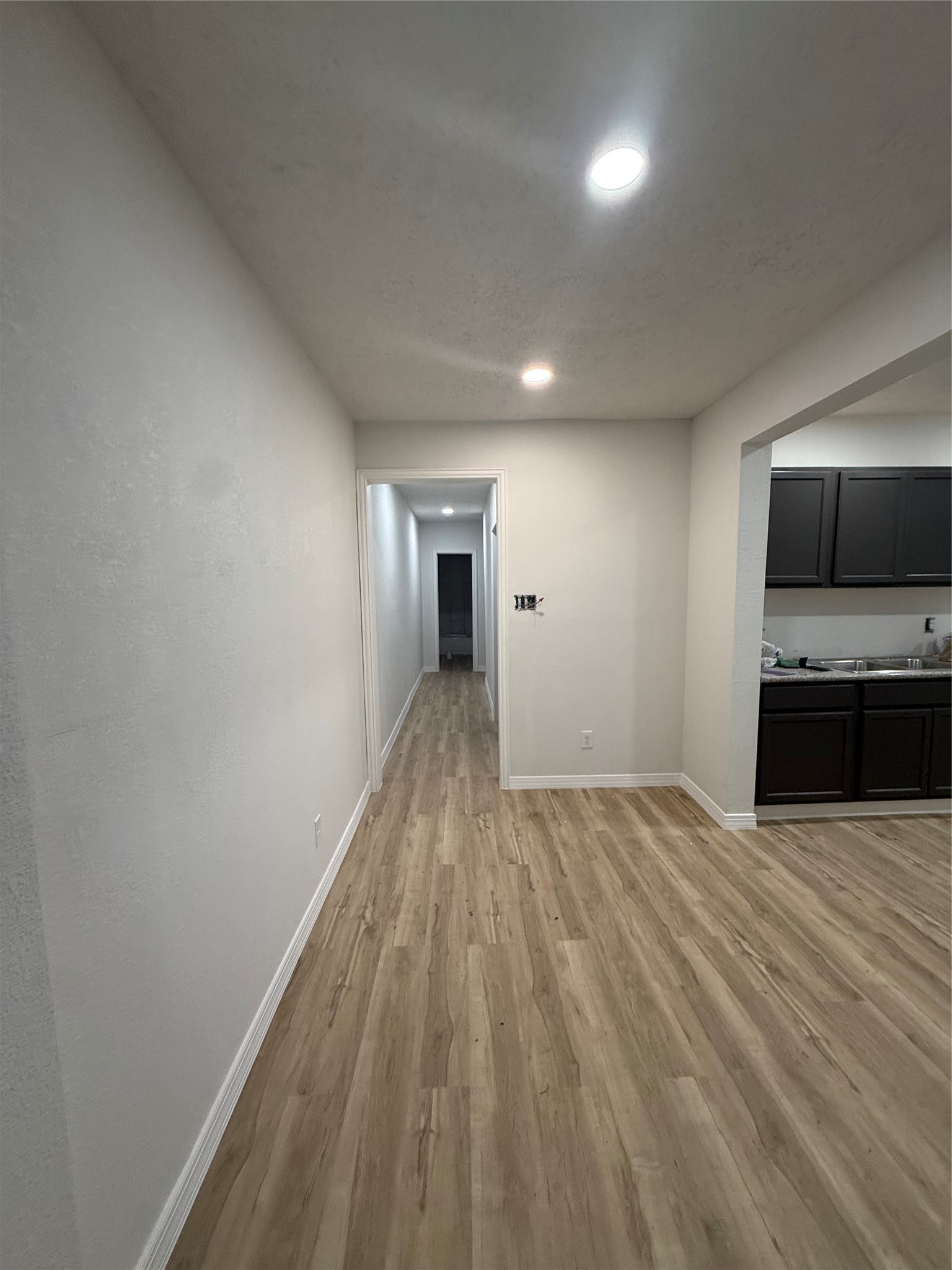 7023 Canal Street Houston, TX 77011 - Photo 2 of 9 a view of a kitchen with wooden floor and a sink