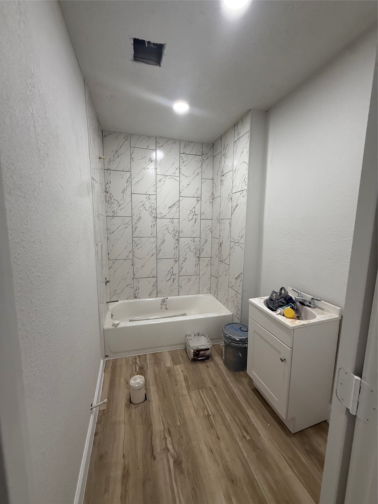 7023 Canal Street Houston, TX 77011 - Photo 5 of 9 a bathroom with a sink a mirror and a bathtub