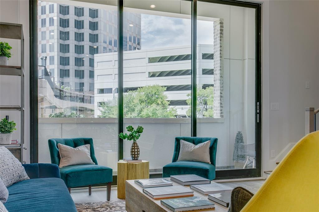 a living room with furniture and a floor to ceiling window