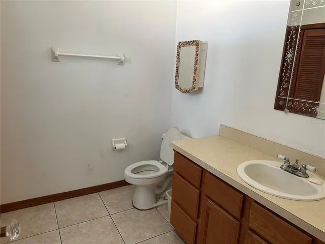 a bathroom with a sink toilet and mirror