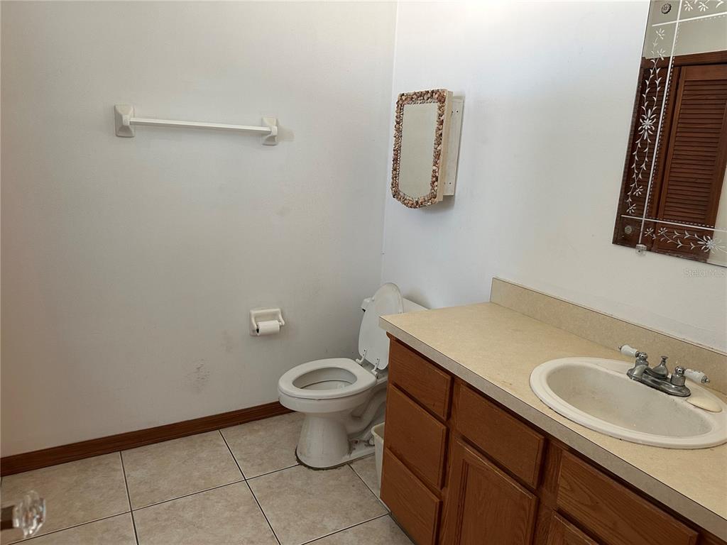2454 Pine Chase Circle St. Cloud, FL 34769 - Photo 4 of 10 a bathroom with a sink toilet and mirror