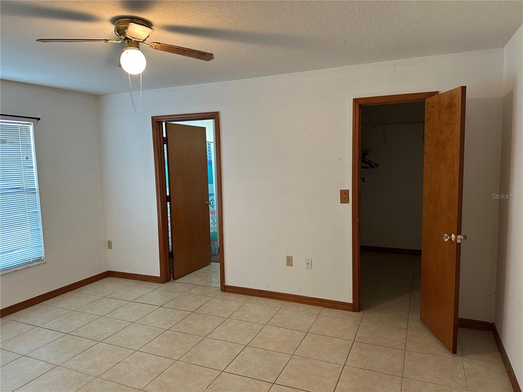 2454 Pine Chase Circle St. Cloud, FL 34769 - Photo 5 of 10 an empty room with closet and a chandelier fan