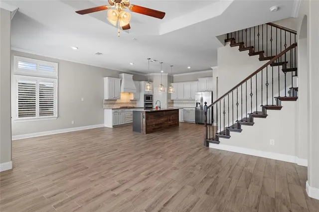 a view of a room with wooden floor and stairs