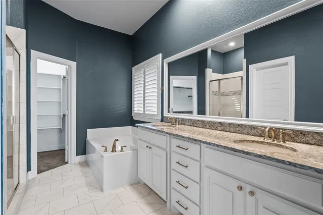 a spacious bathroom with a granite countertop sink mirror and a