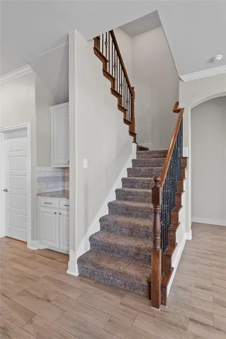 a view of entryway and hall with wooden floor