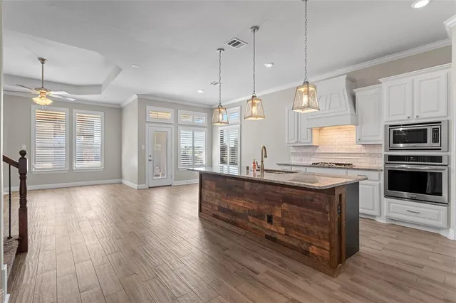a view of kitchen with sink microwave and stove