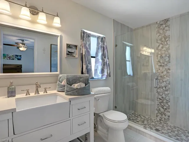 a bathroom with a toilet sink and shower