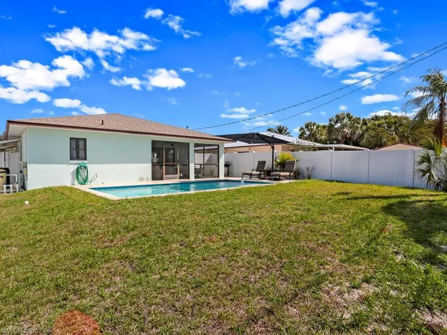 a front view of house with yard and swimming pool