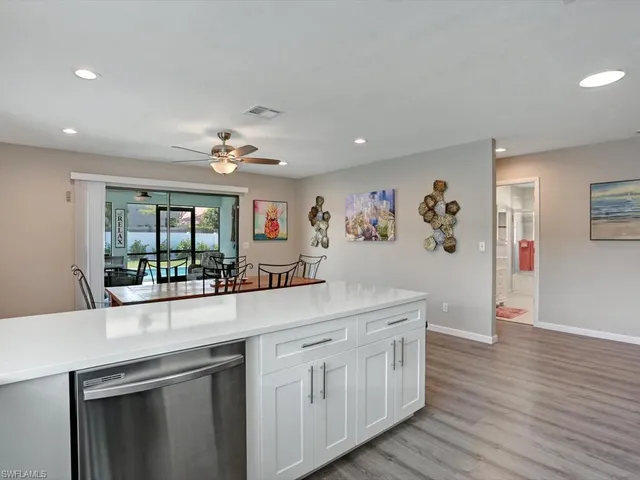 a kitchen with stainless steel appliances granite countertop a lot of counter space and wooden floor