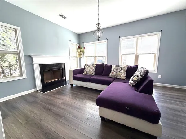 a living room with furniture window and a fireplace