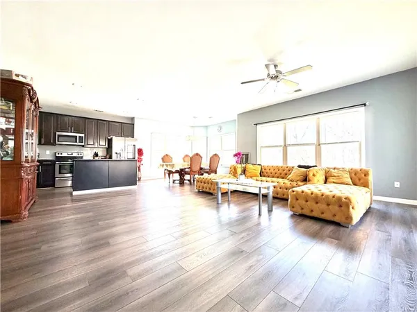 a living room with furniture and a wooden floor