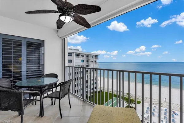 a dining room with furniture and chandelier fan