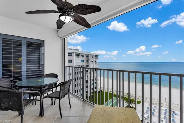 a dining room with furniture and chandelier fan