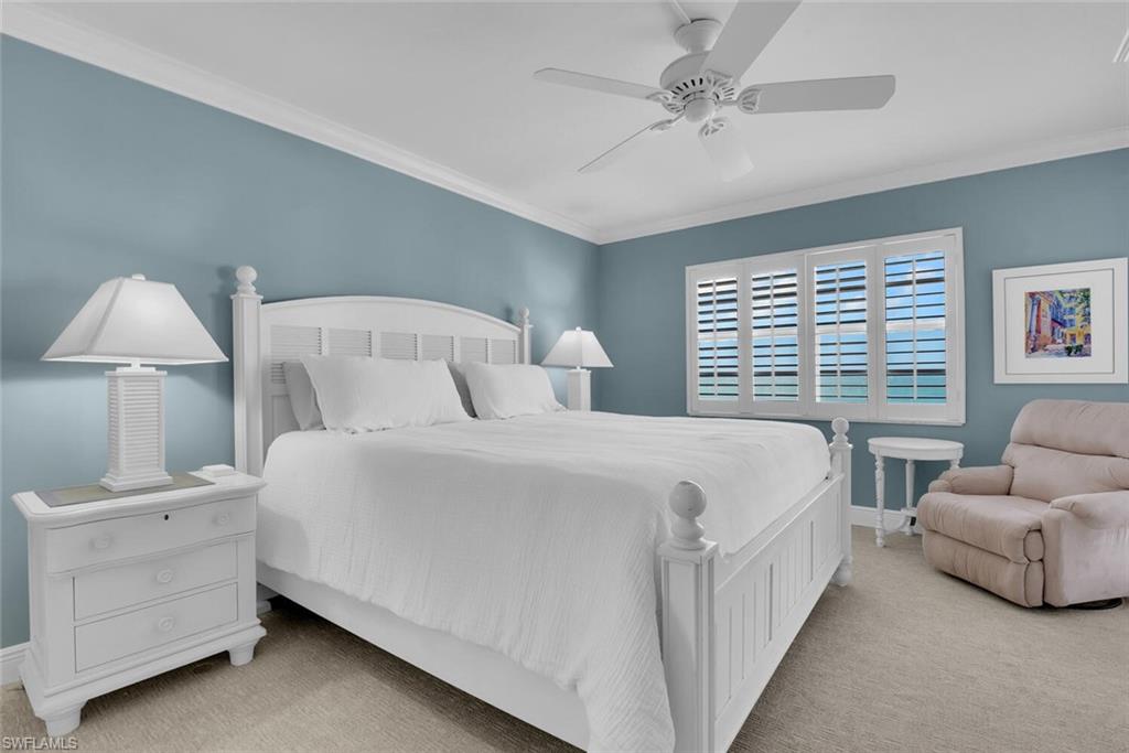 3443 Gulf Shore Boulevard North, Unit 710 Naples, FL 34103 - Photo 13 of 29 a bedroom with bed and a couch