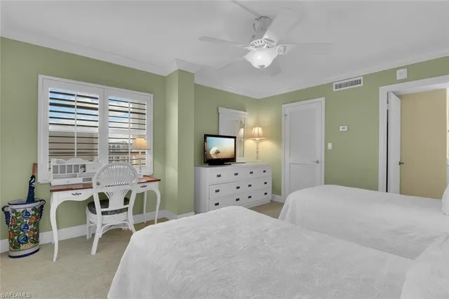 a bedroom with a bed a chair and a large window