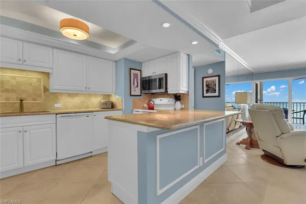 a kitchen with a sink cabinets and window