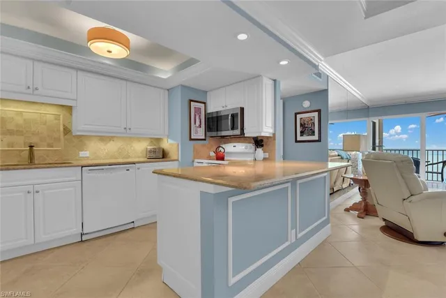 a kitchen with a sink cabinets and window