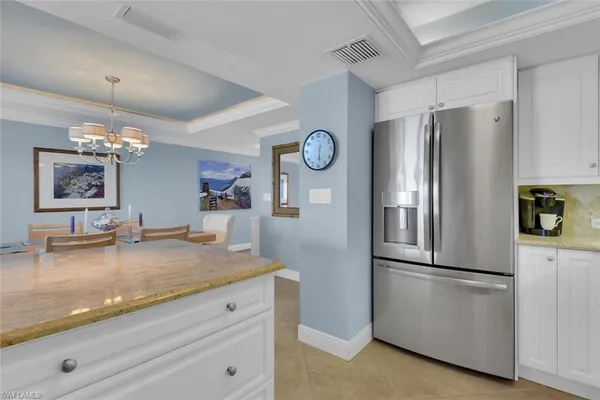 a kitchen with granite countertop stainless steel appliances a refrigerator and a counter top space
