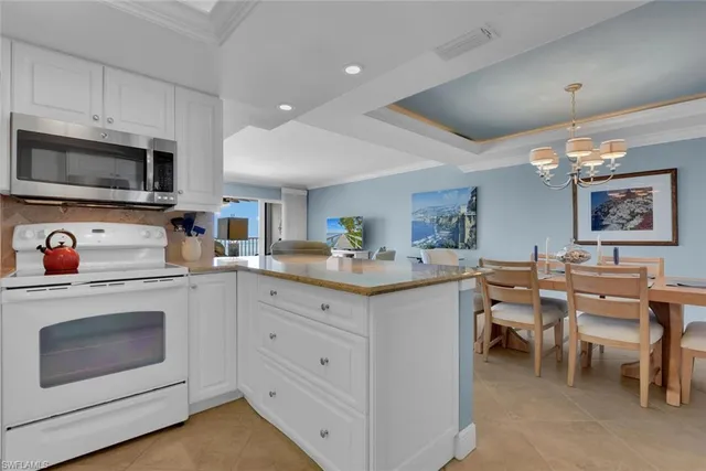 a kitchen with cabinets and chairs