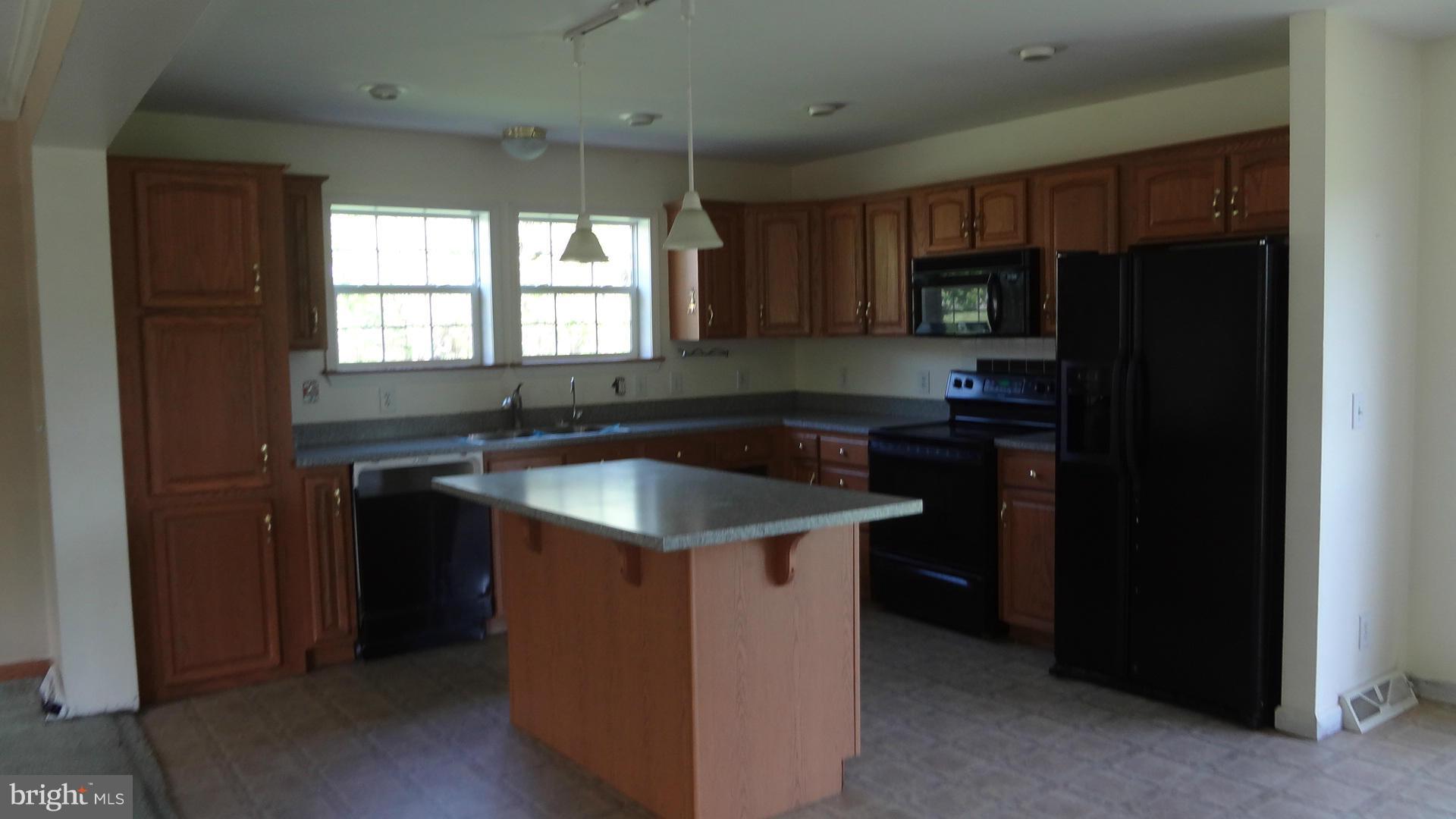 3545 Hopeland Road Frederick, MD 21704 - Photo 4 of 16 a kitchen with a sink a stove a refrigerator and cabinets
