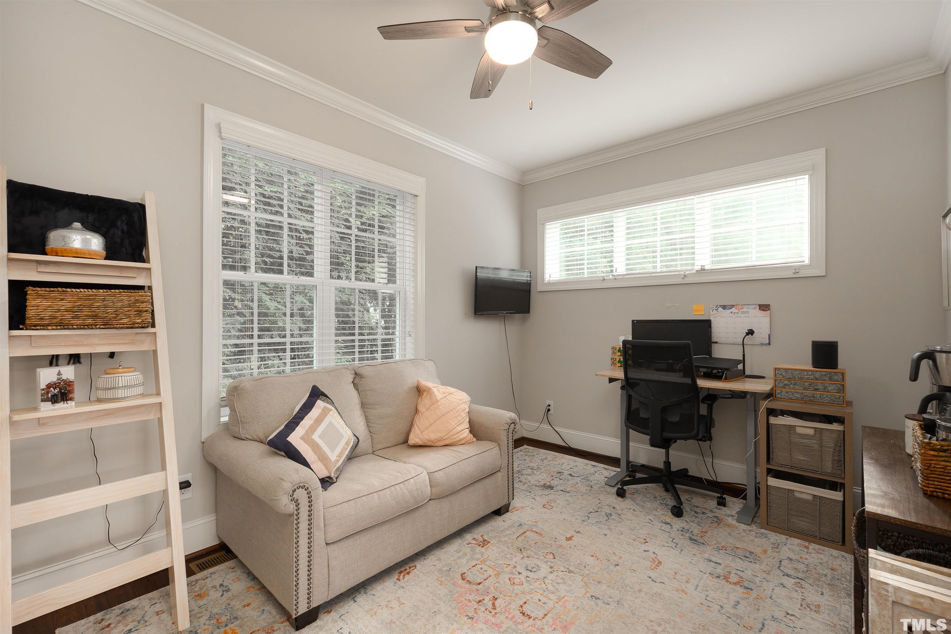 2829 Plumfield Place Raleigh, NC 27607 - Photo 12 of 26 a view of a livingroom with workspace and a window