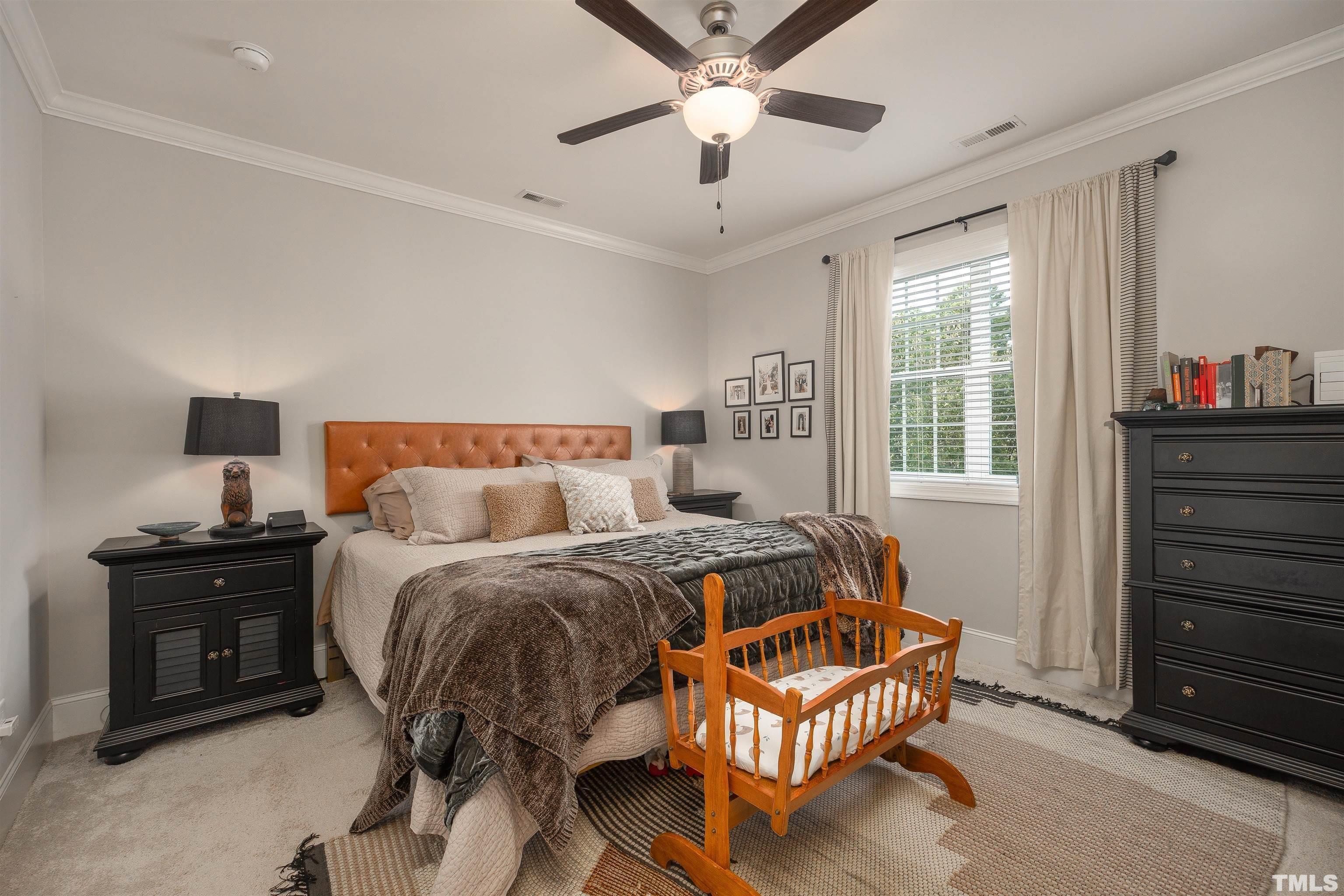 2829 Plumfield Place Raleigh, NC 27607 - Photo 13 of 26 a bedroom with a bed and wooden floor