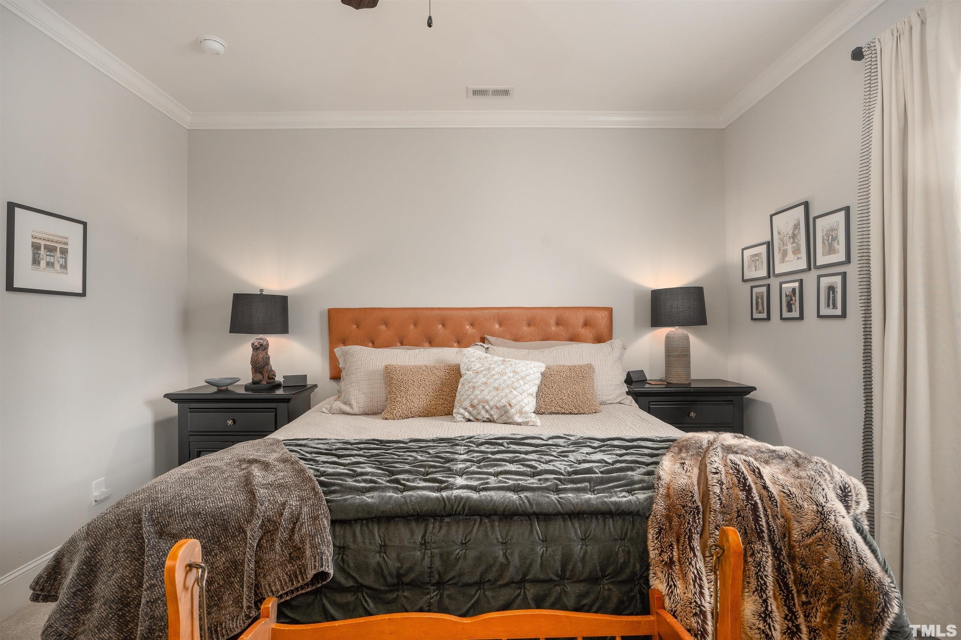 2829 Plumfield Place Raleigh, NC 27607 - Photo 14 of 26 a bedroom with a bed and a night stand